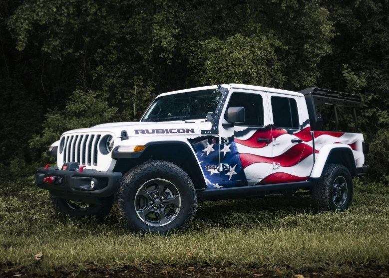 A jeep truck with an American flag wrap