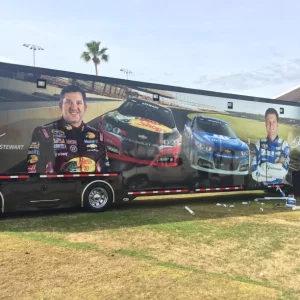 Black Semi Trailer with Nascar Drivers and Two Nascar vehicles