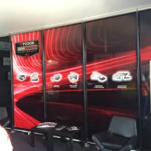 Red and black panels with logos and black chairs