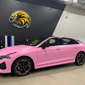 Sedan Wrapped in Pink with Bird Logo On Wall